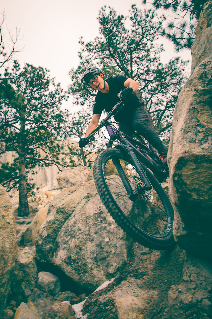 Gabe Rivera riding through a rock notch on Black Sheep trail in Colorado Springs Colorado.