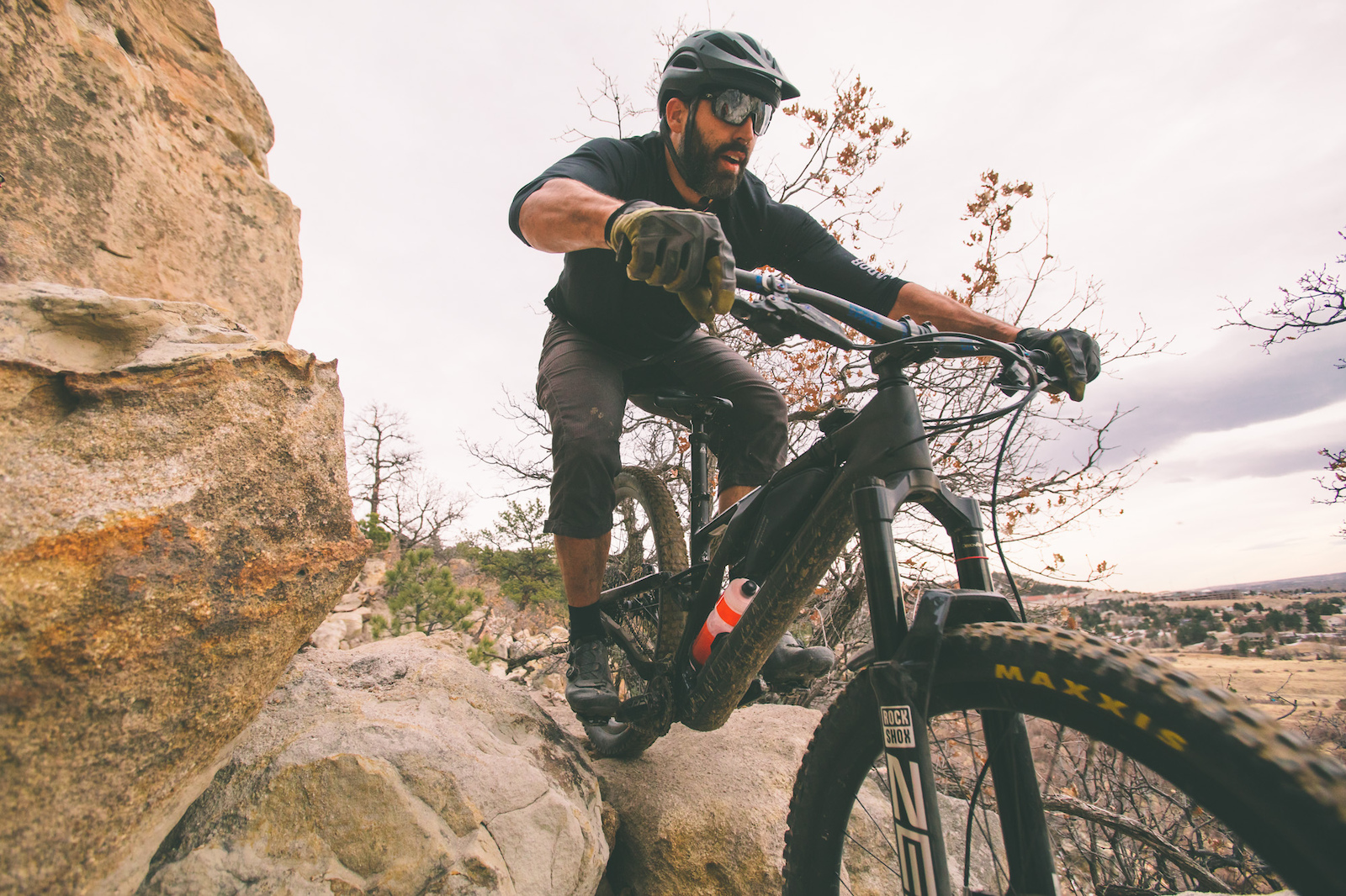 Criterium Bike Shop employee Aaron Kacala navigates a rock notch on Black Sheep Trail at Austin Bluffs Open Space in Colorado Springs Colorado.